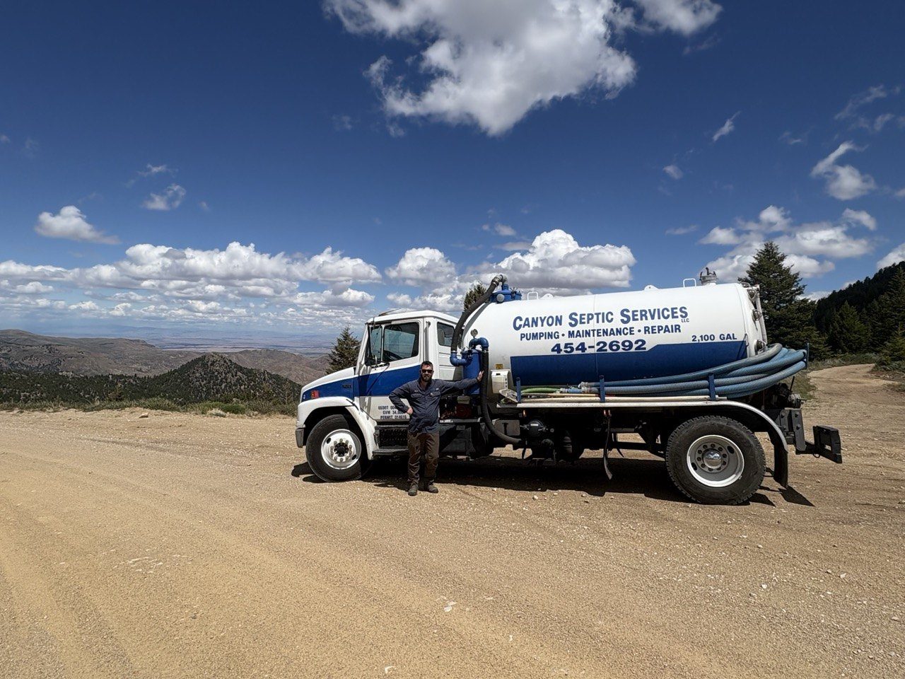 Canyon Septic Services pumper truck on a Treasure Valley mountain road