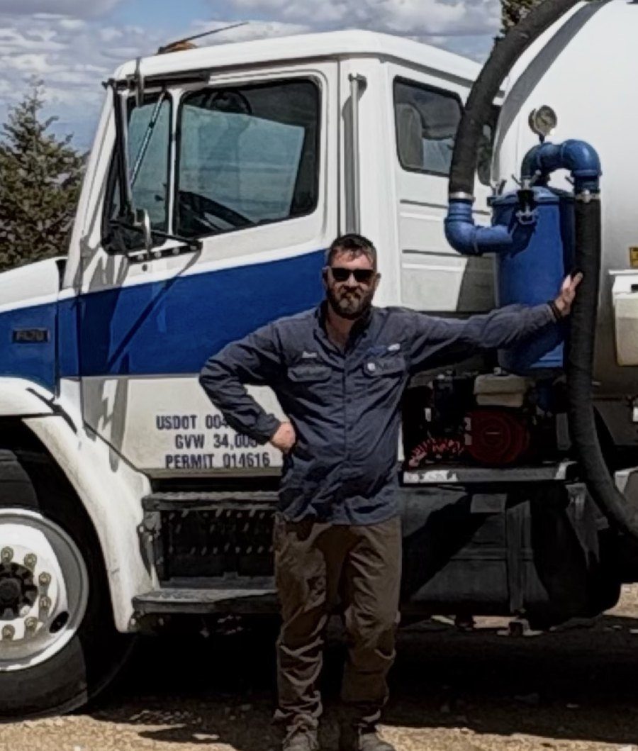 Zach McKellar, owner, beside the Canyon Septic truck